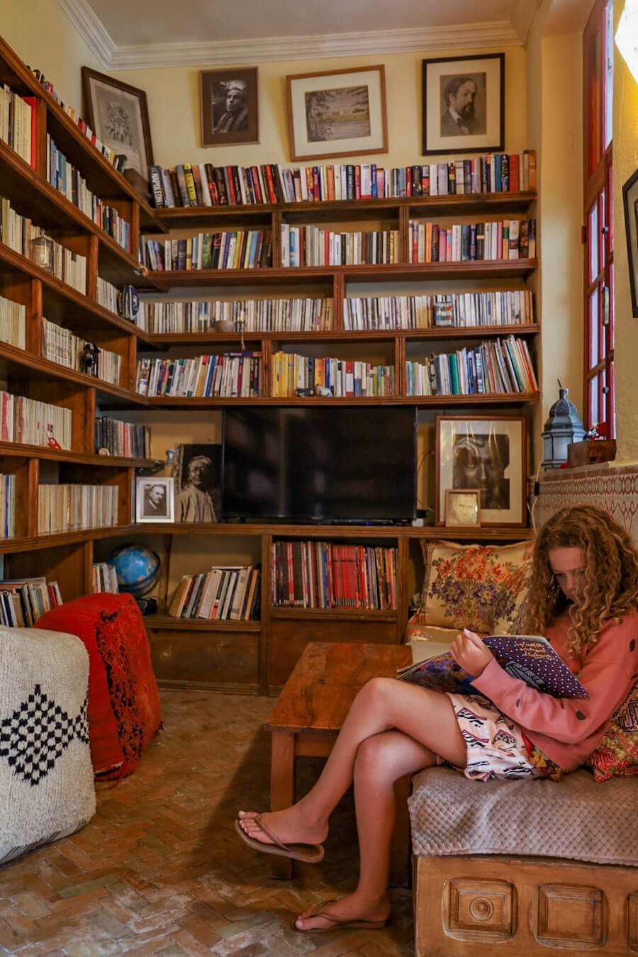 Child reads in the library at Ryad Watier in Essaouira