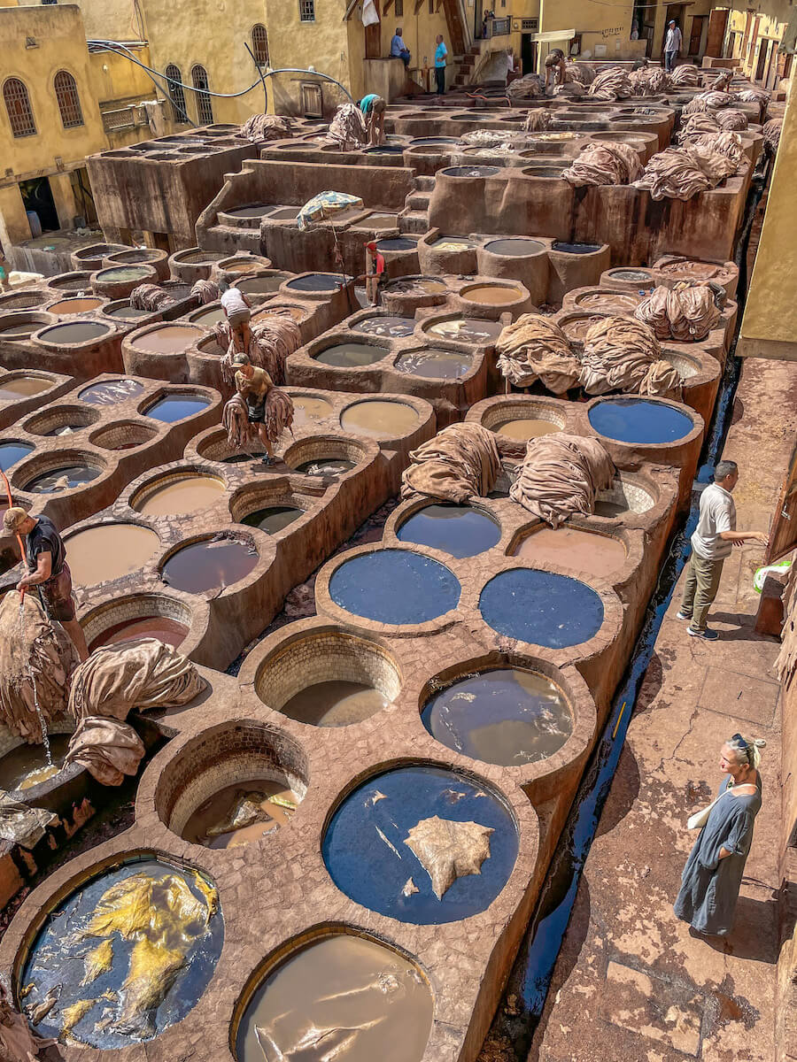 A woman on a tour in the Chouara Tannery in Fes - one of the most frequently visited locations when visiting North Morocco on an itinerary of 12 days.