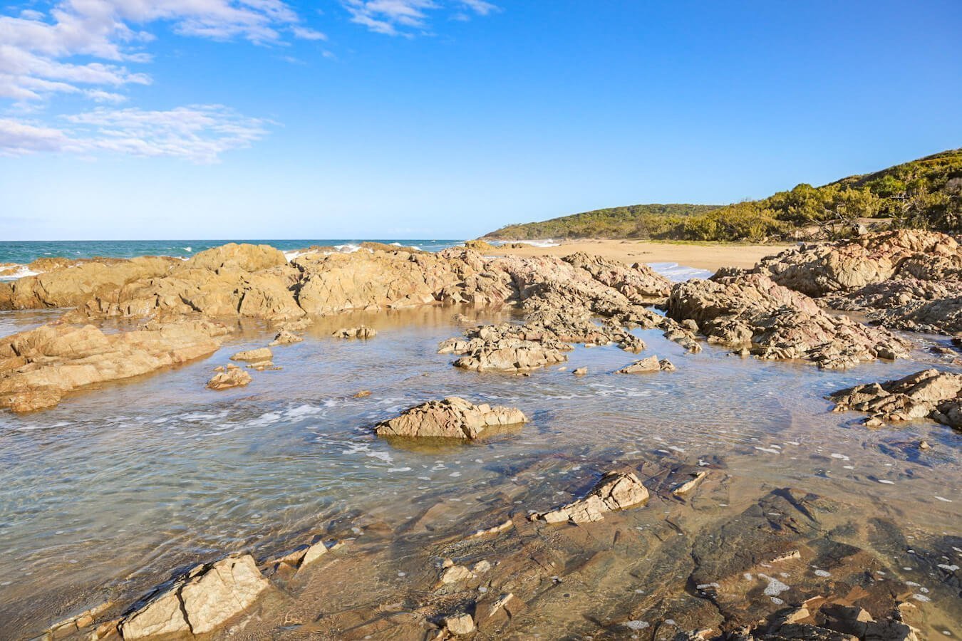 The beautiful Red Rock beach and rock pools in Agnes Water - one of the best walking activities to do if visiting