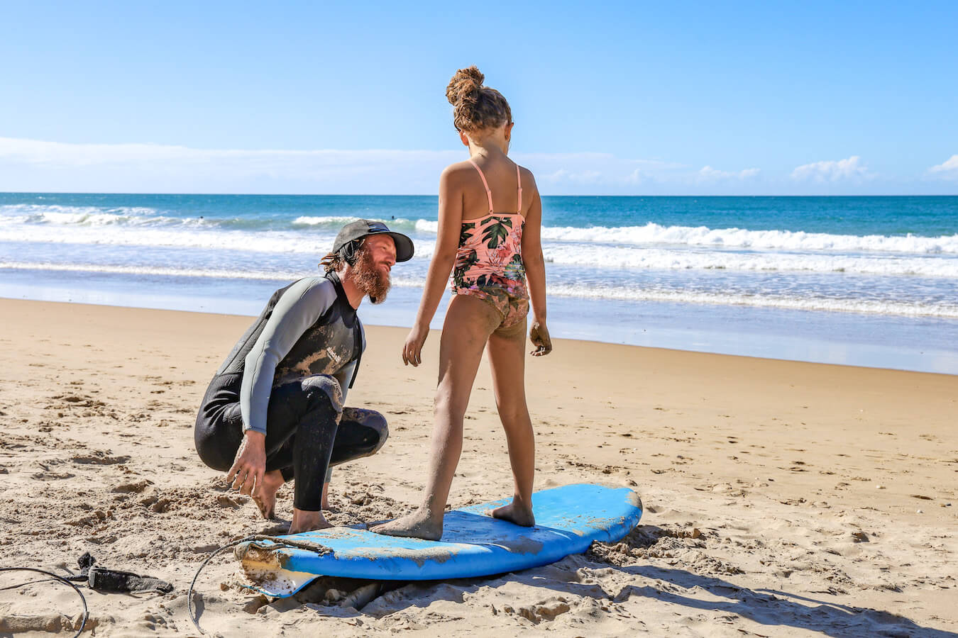 A child learns to surf in Agnes Water Australia