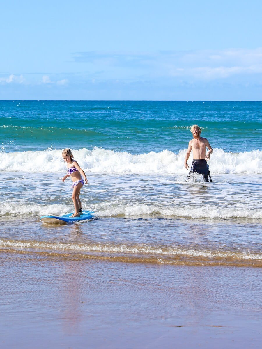 A child learns to surf in Agnes Water Australia.