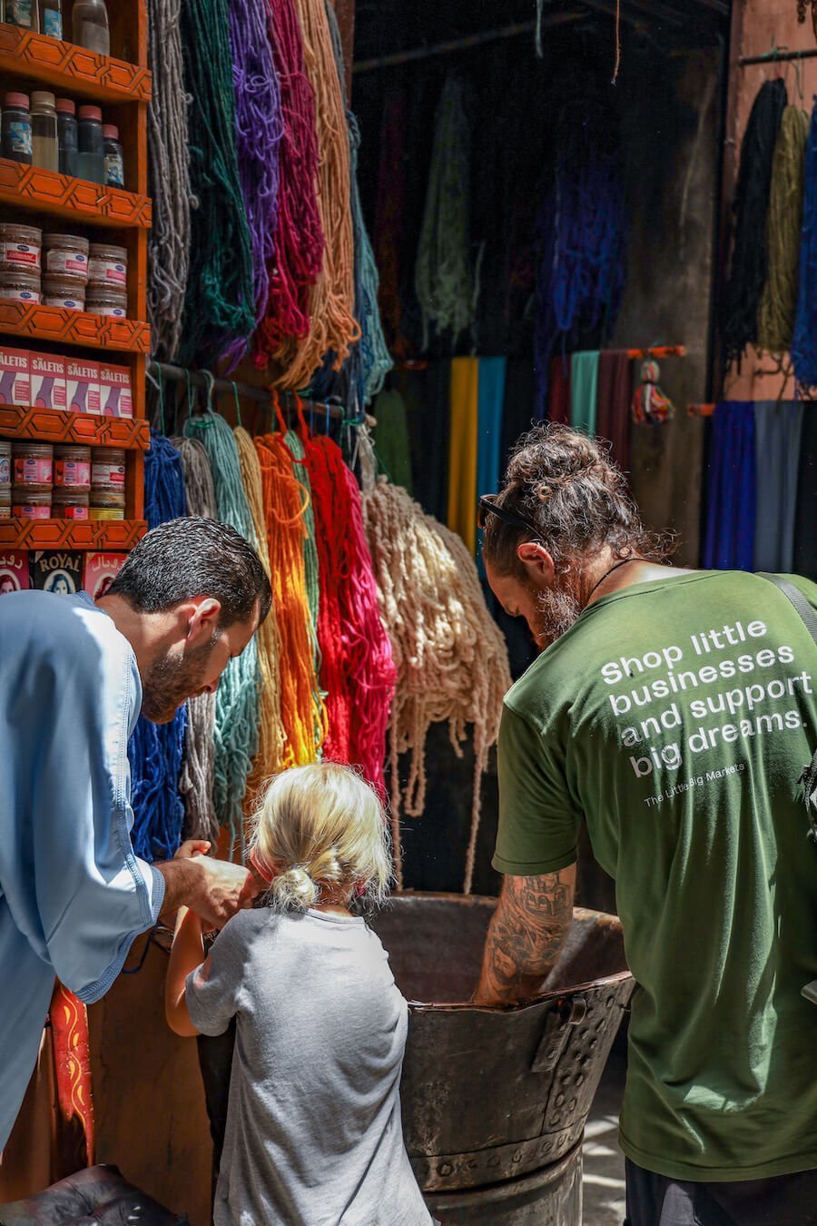 A family are shown how wool is coloured in the Marrakech Medina