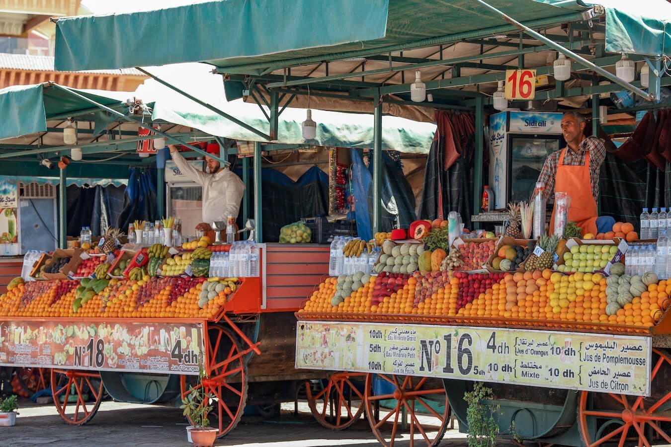 Men sell orange juice in Djemaa el-Fna Square - this is a popular thing to do when visiting 3 days in Marrakech