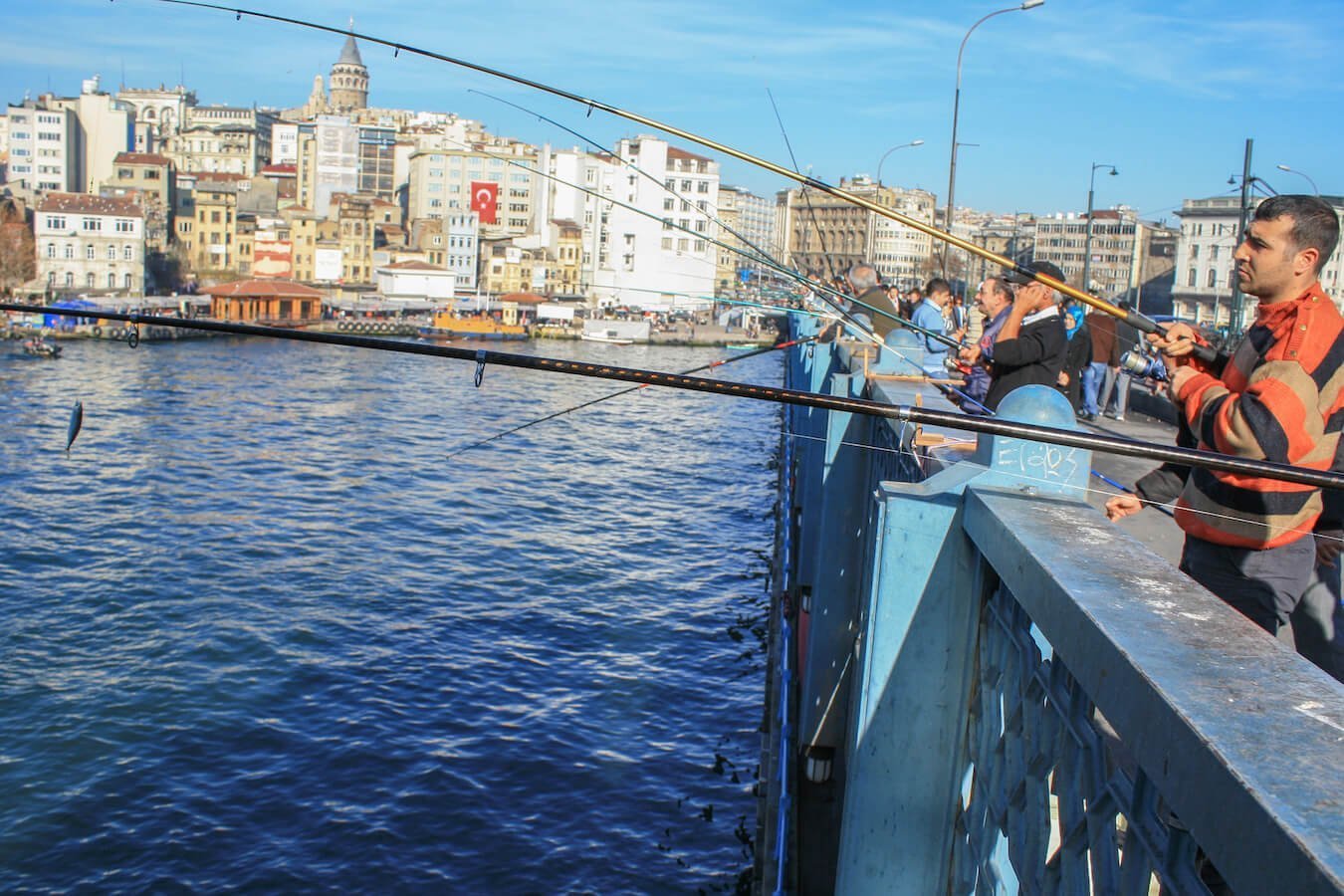 Men fishing over the Golden Horn from the Galata bridge in Istanbul