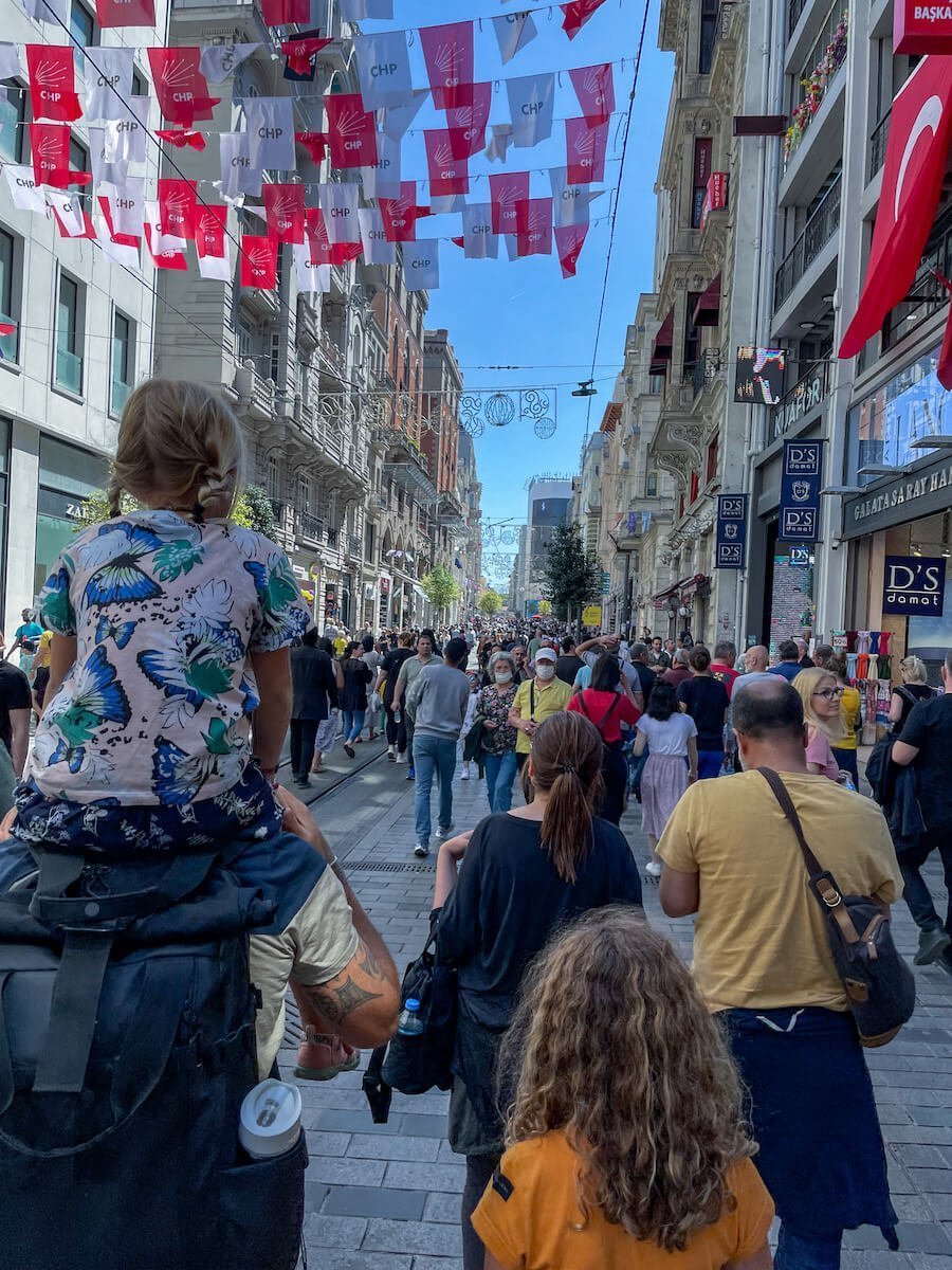 Family walk Istiklal Avenue among crowds of tourists.  This is one of the most popular tourist destinations and places to visit over 4 days in Istanbul