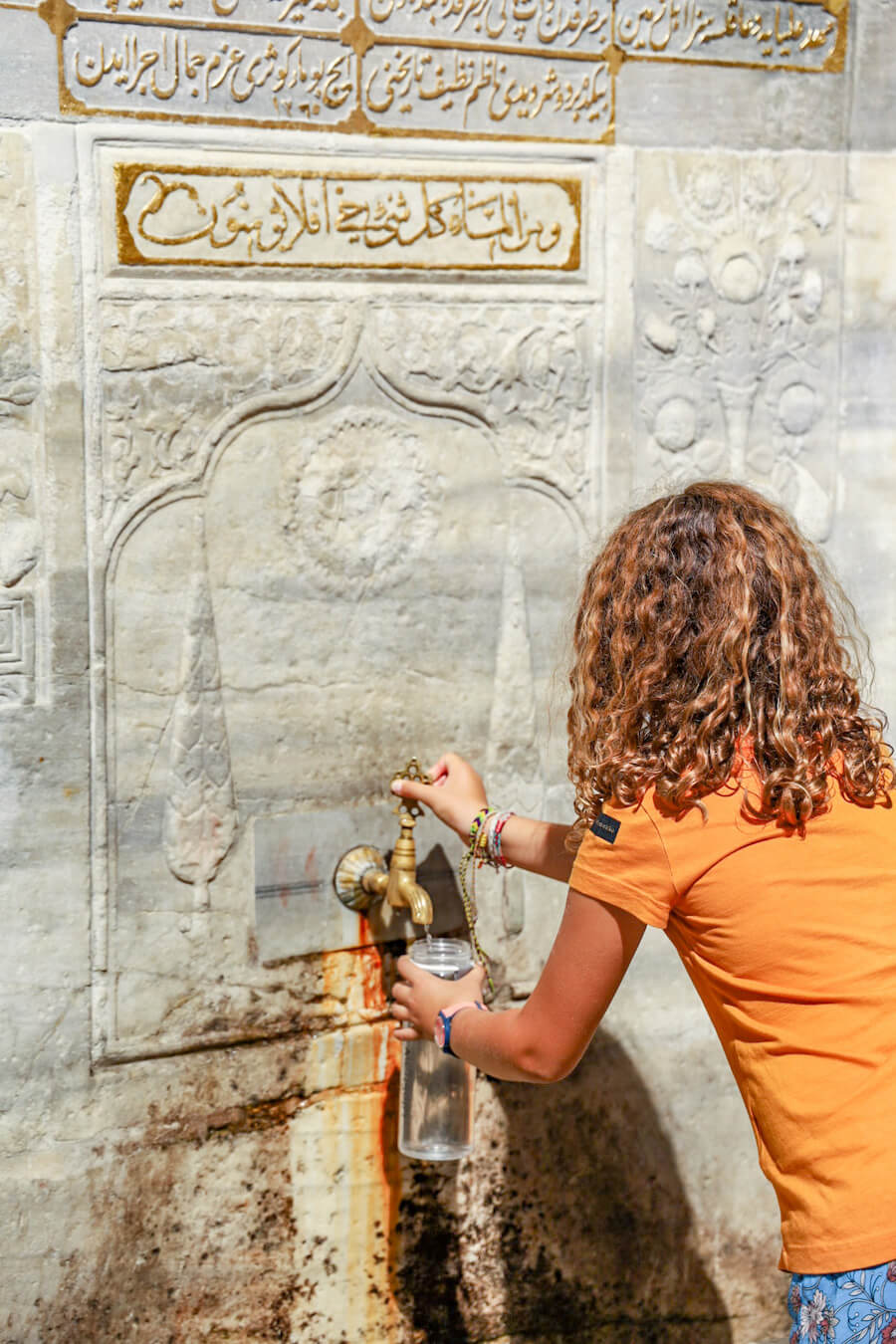 Child fills a Lifestraw from the washing station near the galata tower in Istanbul.