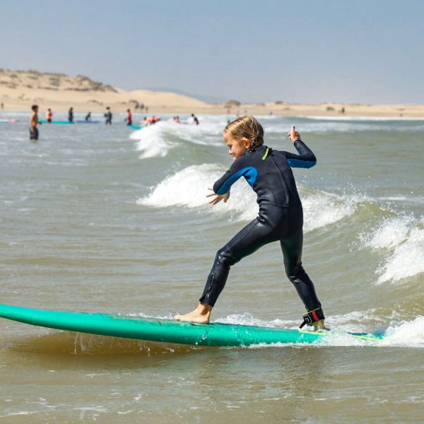 A child surfs on the beach in Essaouira - a popular destination for an 8 days itinerary of the Atlantic Coast