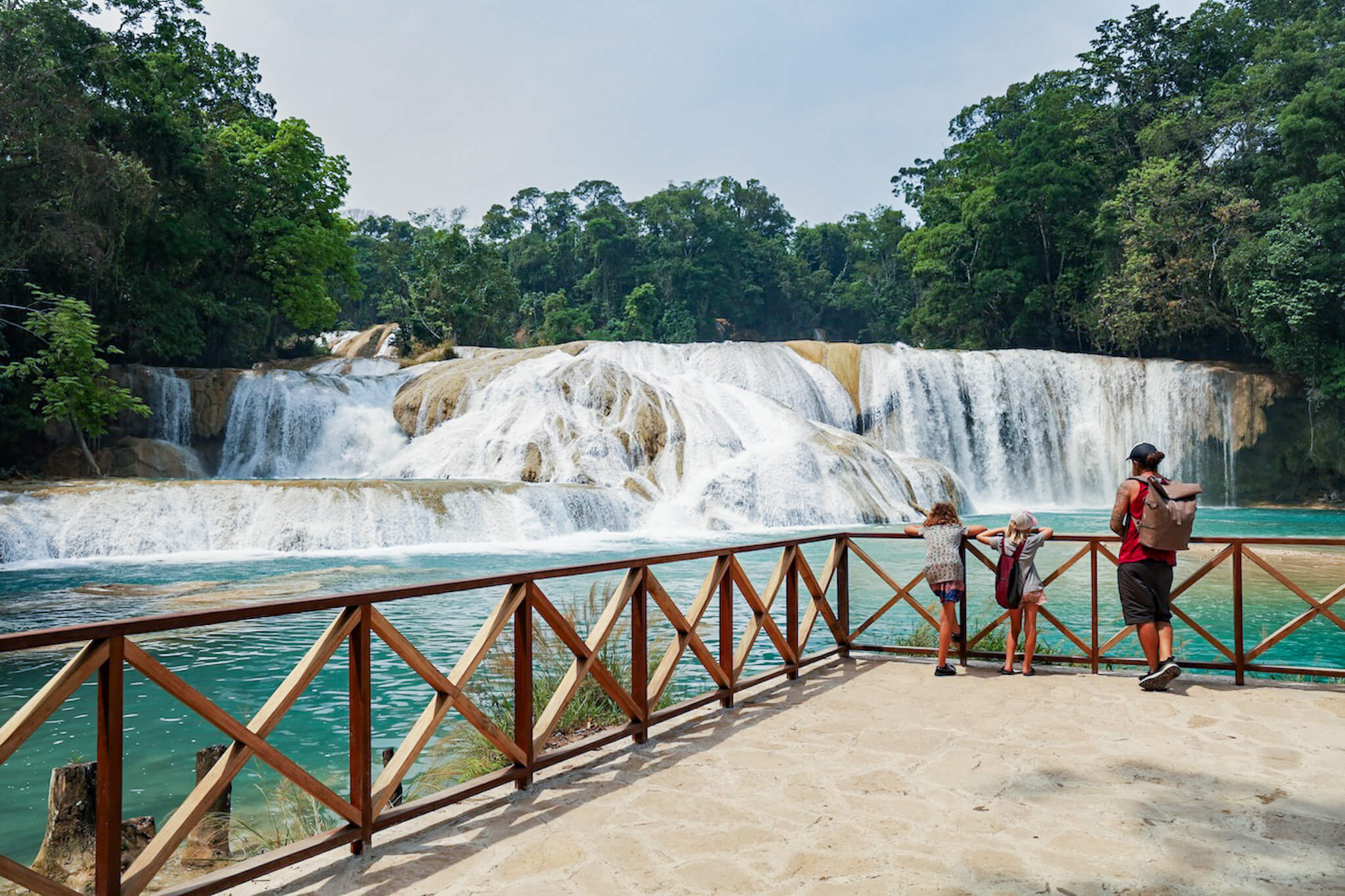 A family admire the Agua Azul waterfalls from the viewing platform in Mexico.