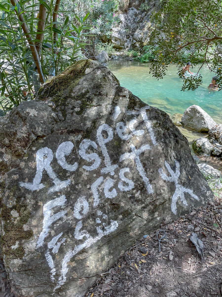 A Berber message reminded visitors who come to see Akchour and God's Bridge to respect the forest - a sign is painted on the rock with the freeman symbol.