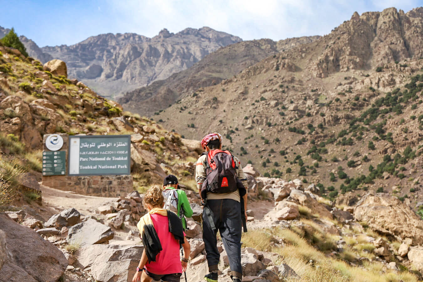 Ahmed Zin walking with kids on a hike of the Atlas Mountain range in Morocco on a family tour