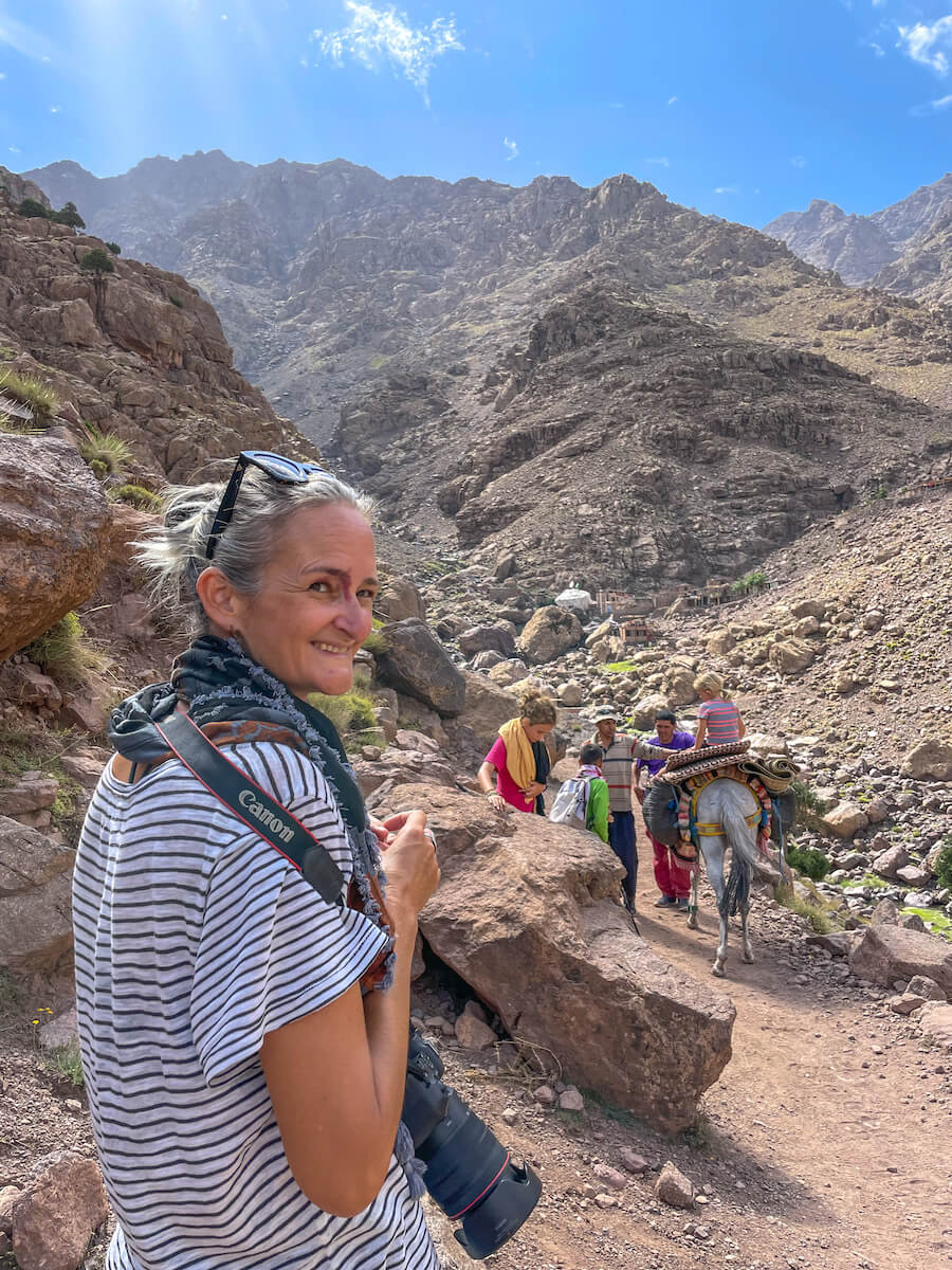 Woman and Canon camera - looking for the best photo opportunity in the Atlas Mountain Range in Morocco