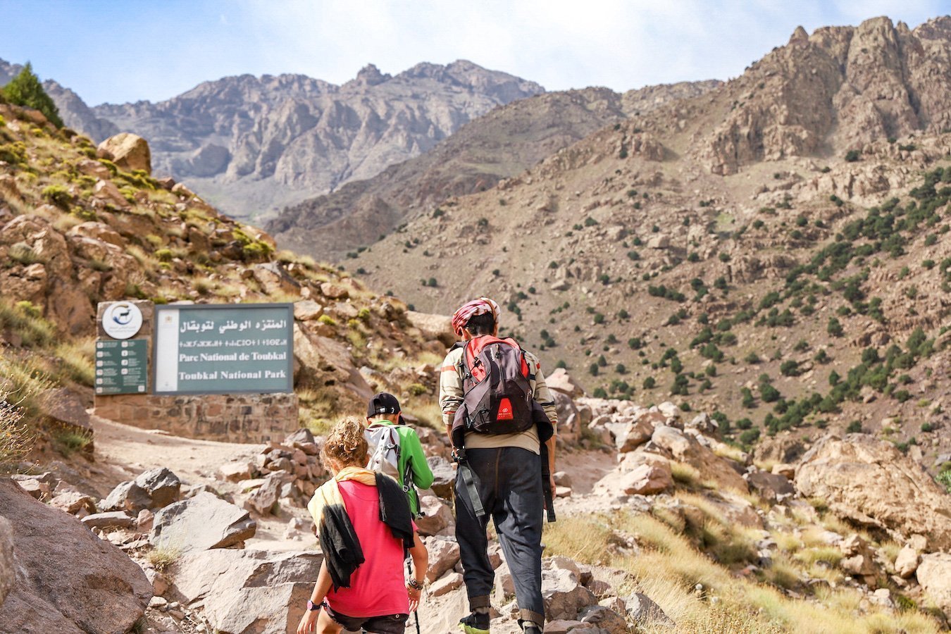 Local guide begins the ascent trekking in the Atlas Mountain Range towards Toubkal National Park
