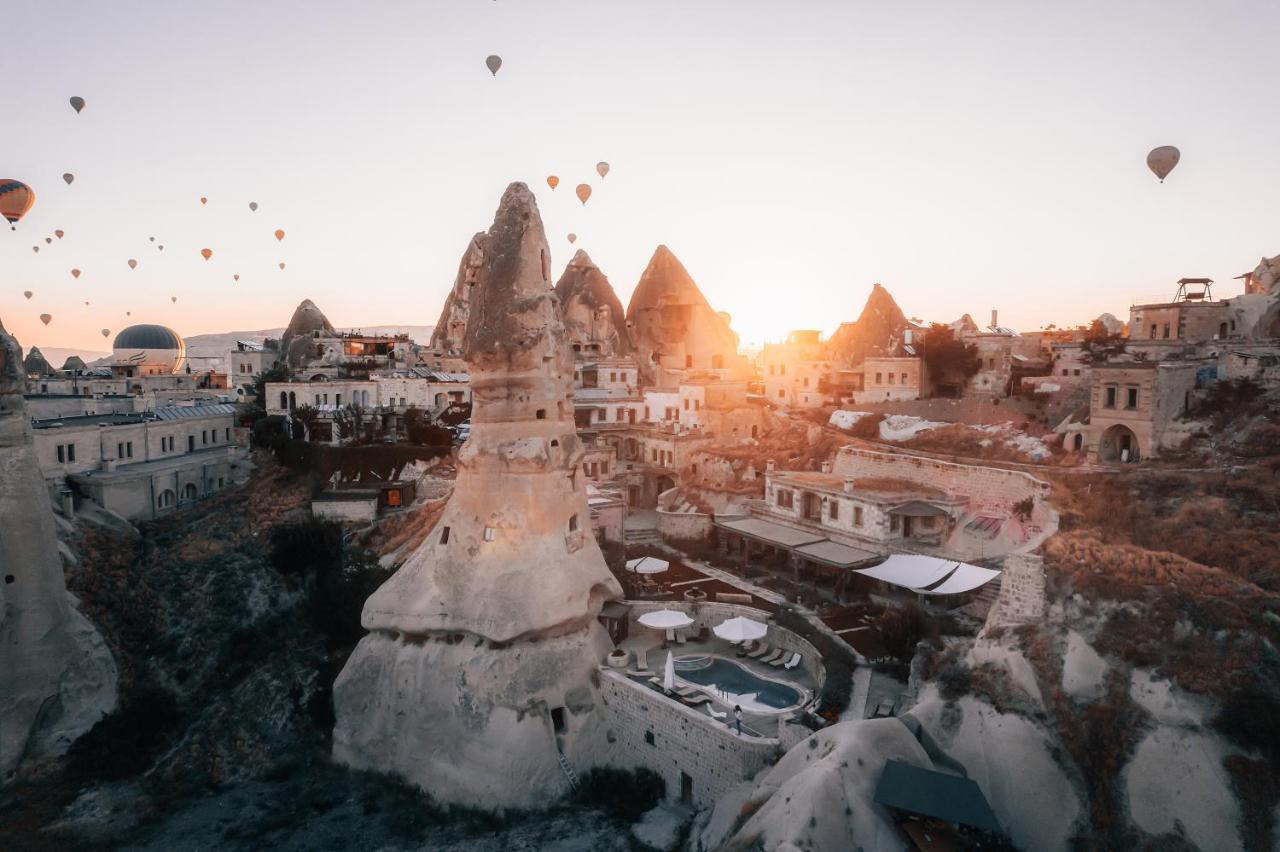 One of the best - the luxury hotel Aza Cave Cappadocia with views of the cave rooms, pool, fairy chimneys and hot air balloons flying in the distance. 