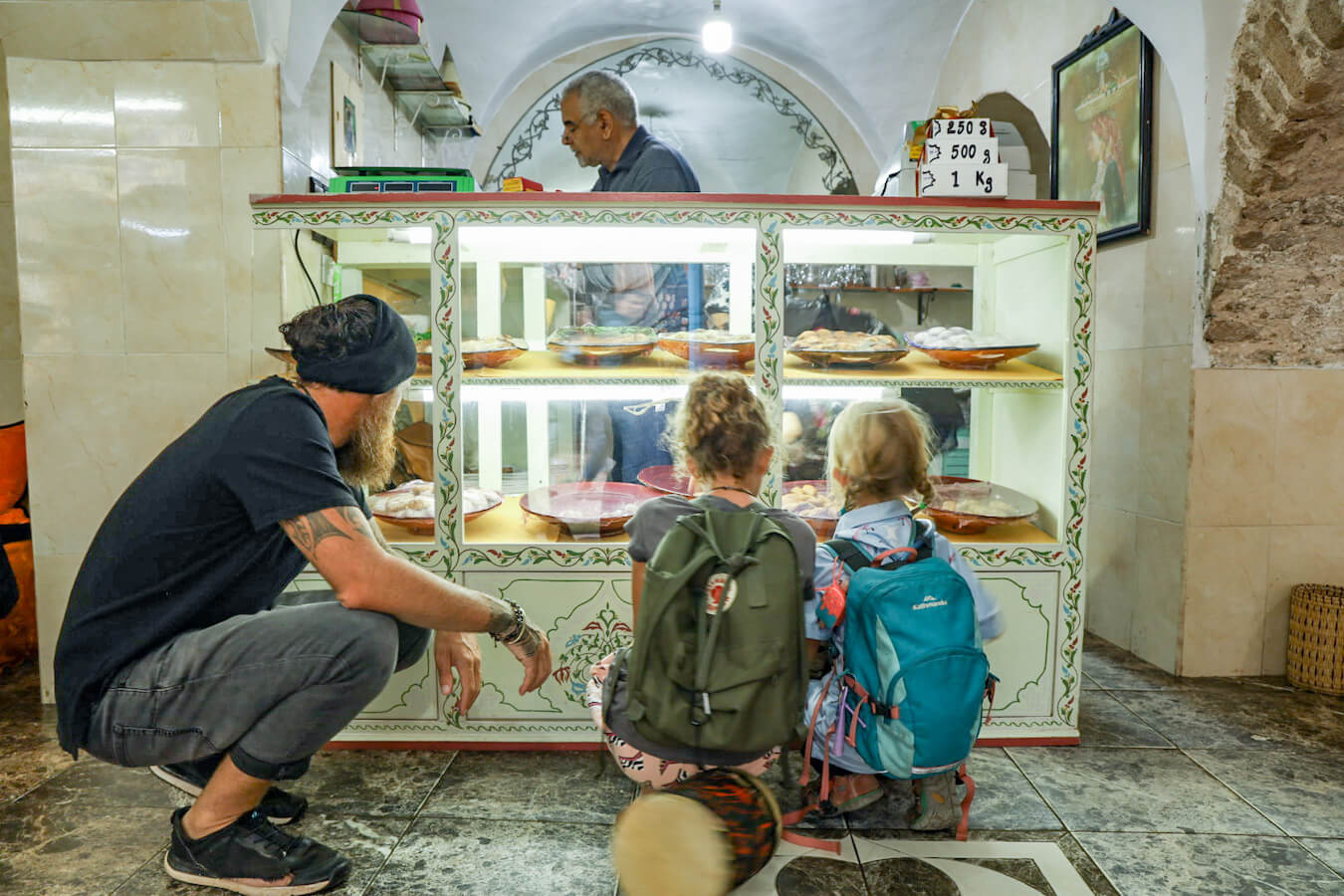 Children choose biscuits from a patisserie in Essaouira