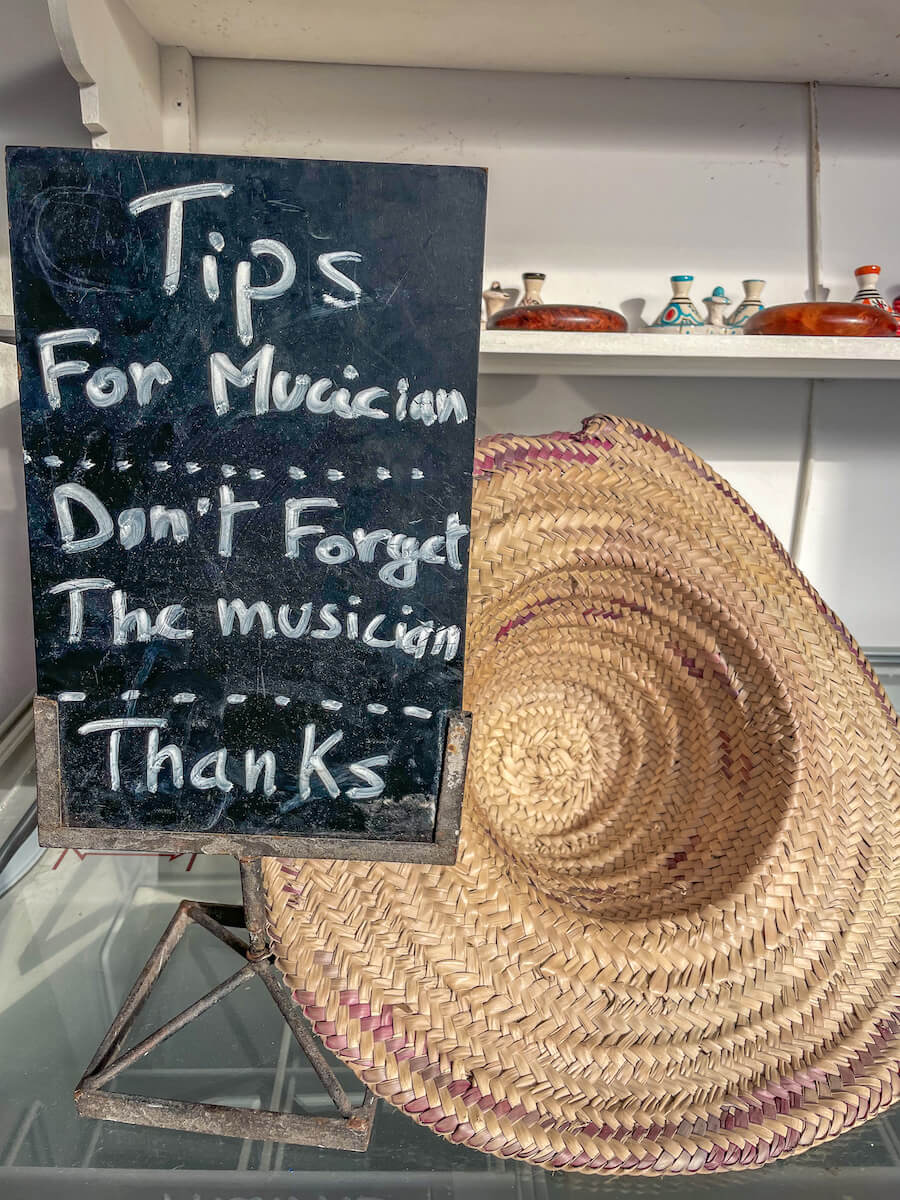 A hat sits on the table waiting for tips for the Gnaoua musicians