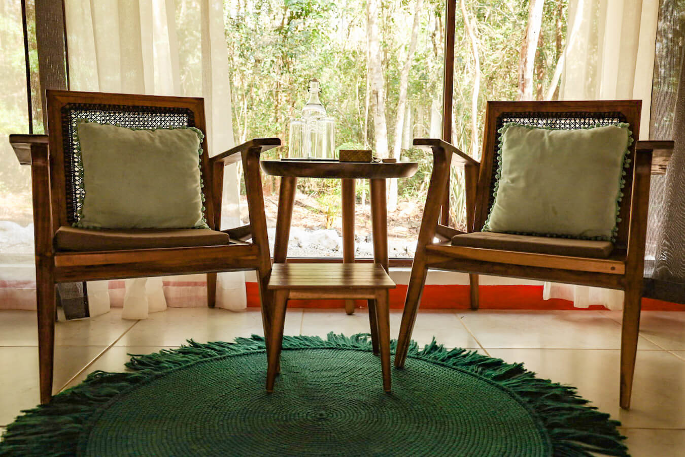 The bedroom furniture overlooking the jungle at Cenote Secreto Maya.