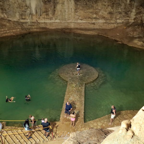 Tourists gather for photos on the platform at Cenote Suytun near Valladolid, Mexico.