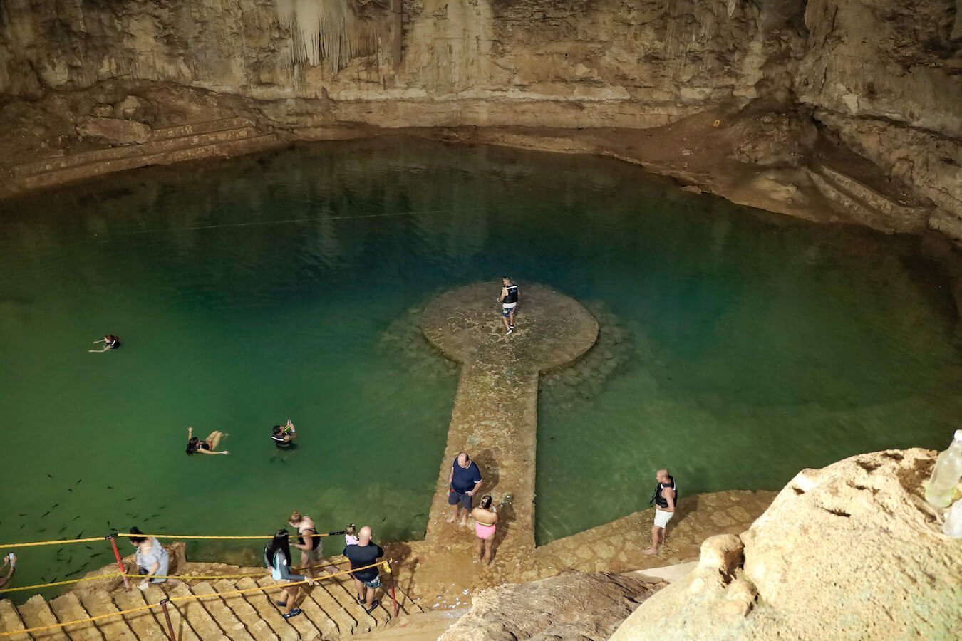 Tourists gather for photos on the platform at Cenote Suytun near Valladolid, Mexico.