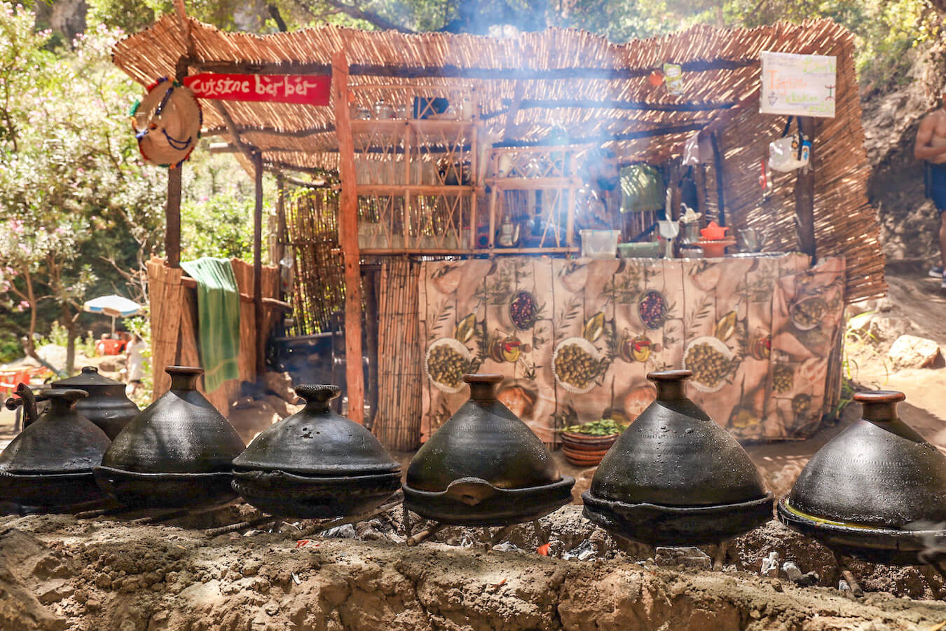 A tagine cooks over coals on the Akchour trail towards God's Bridge - this is a good day trip and one of the top things to do when visiting Chefchaouen