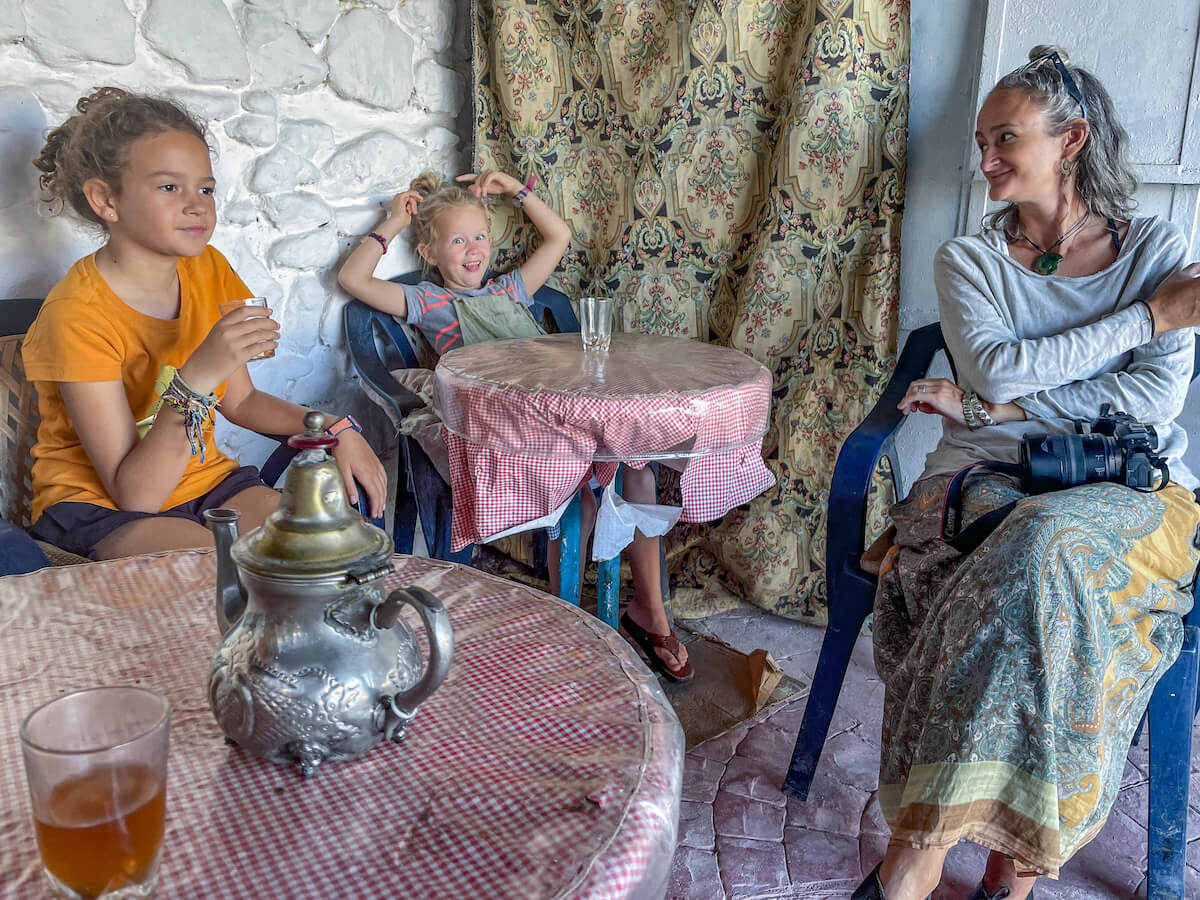 A family sit for a cup of mint tea at the vegetable market and souk in Morocco