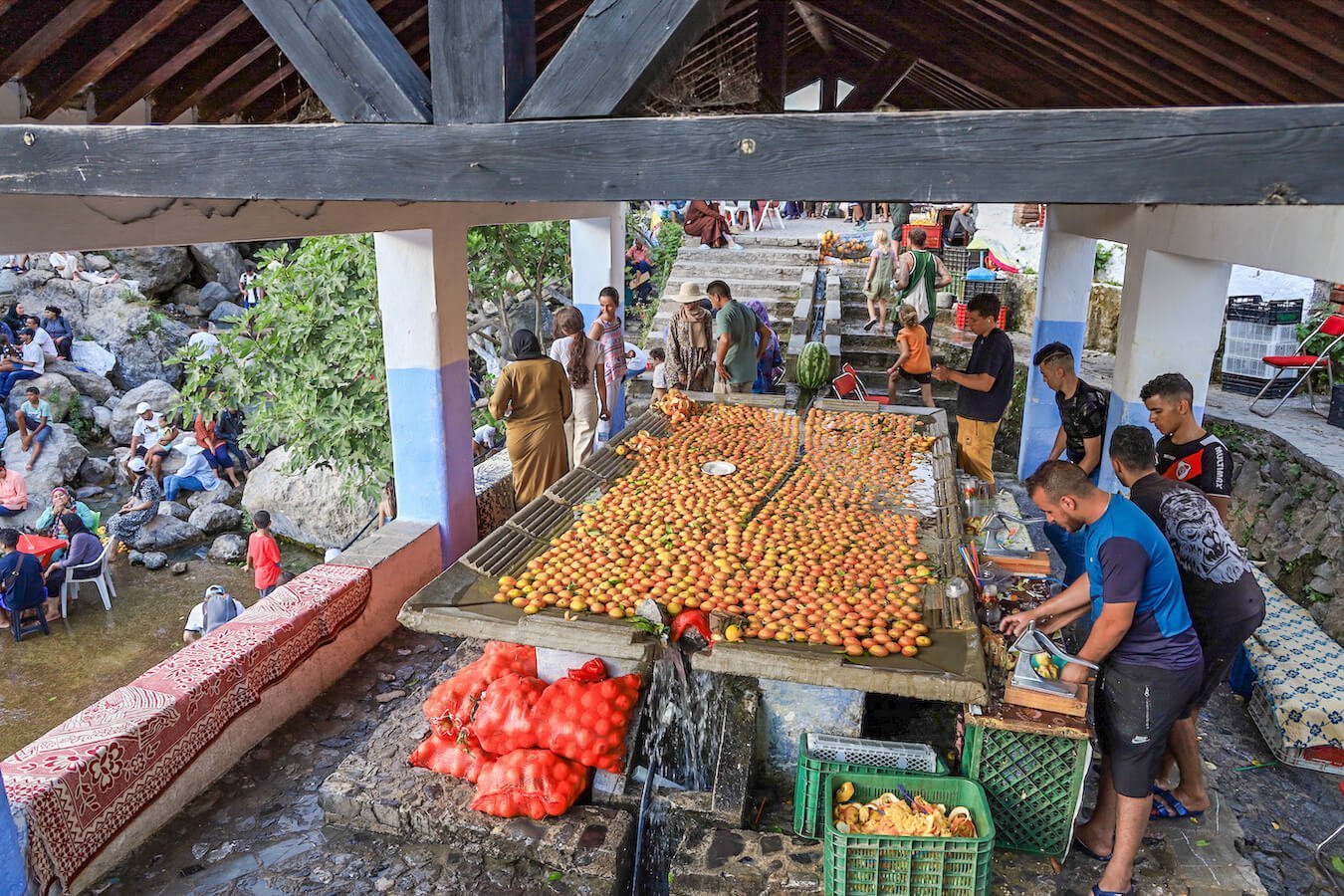 The busy orange juice making stall in Chefchaouen, Morocco - one of the top things to do in Chefchaouen