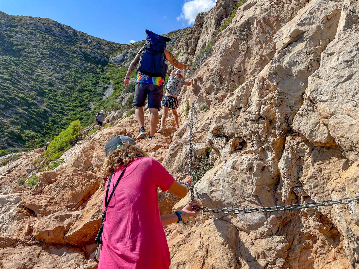 A family walk the rocky trail of the PR CV 355 trail near Javea / Xabia in Spain