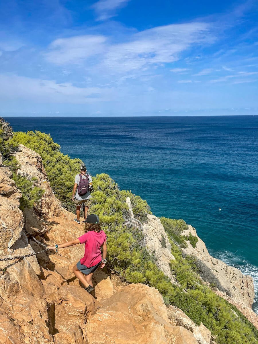A mother and daughter walk a trail within the Montgo Natural Park