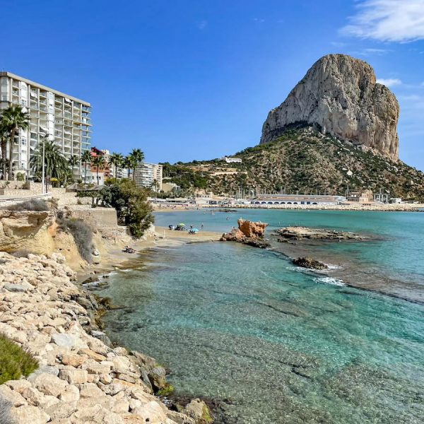 The impressive Calpe rock in Spain, overlooking the fishing port and Cantal Roig Beach - as seen on a day trip from Javea