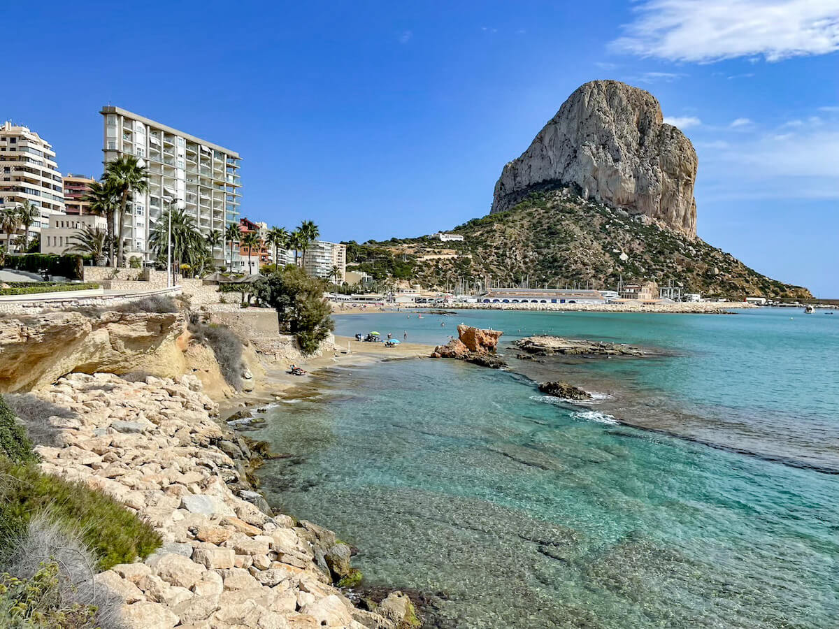 The impressive Calpe rock in Spain, overlooking the fishing port and Cantal Roig Beach - as seen on a day trip from Javea