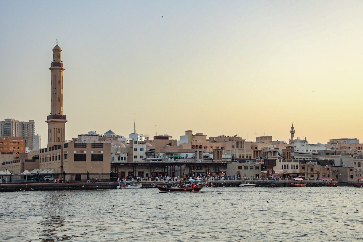 The Dubai Creek at sunset as an abra crosses to the other side. 