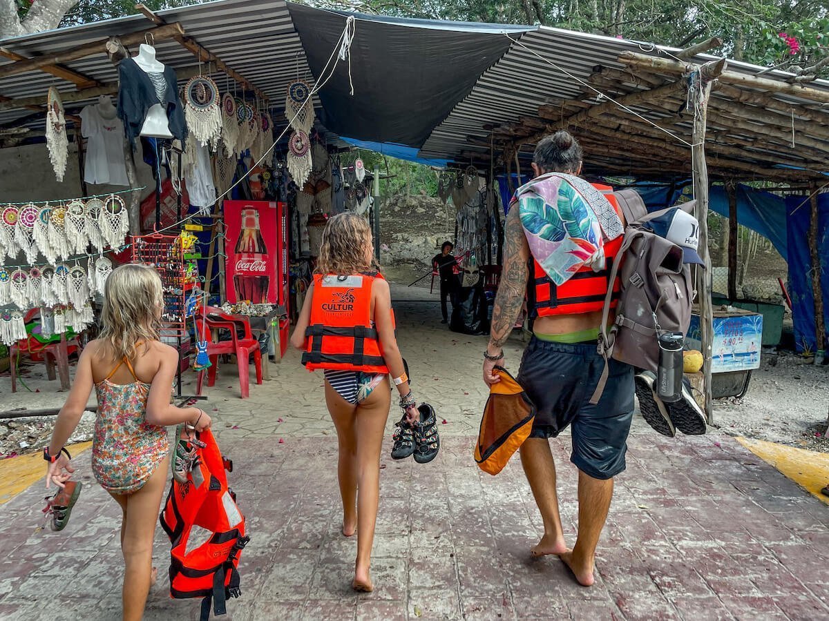 A family cross the street between Samula and Xkeken Cenote at Dzitnup in Valladolid.