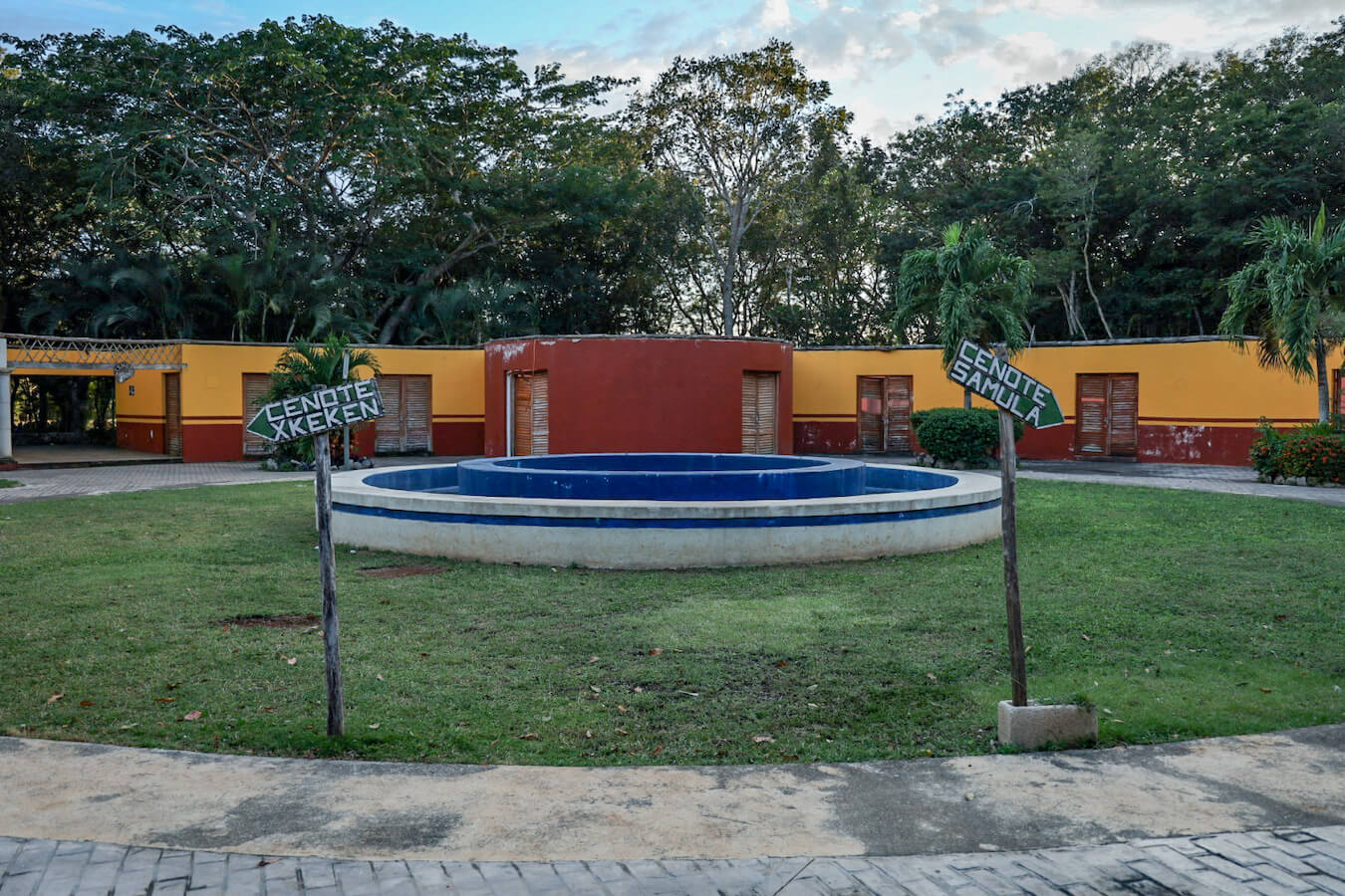 The entrance to the Valladolid Dzitnup cenotes with signs pointing towards Cenote Xkeken and Cenote Samula.