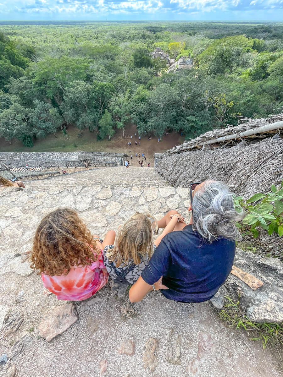 A mother and kids look over Ek' Balam jungle after climbing to the top of the ruins