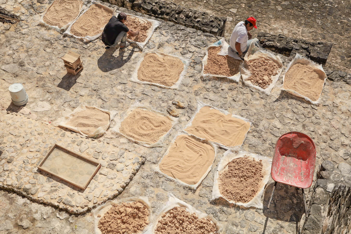 Men working at the Ek' Balam Archeological Ruins get ready to make restorations on the stucco facade of the Mayan carvings