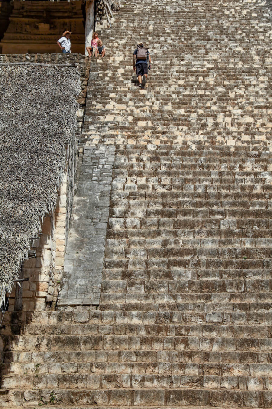 A visitor on a self-guided tour of Ek' Balam walks the steep stairs towards the top of the Acropolis AKA Royal Palace 