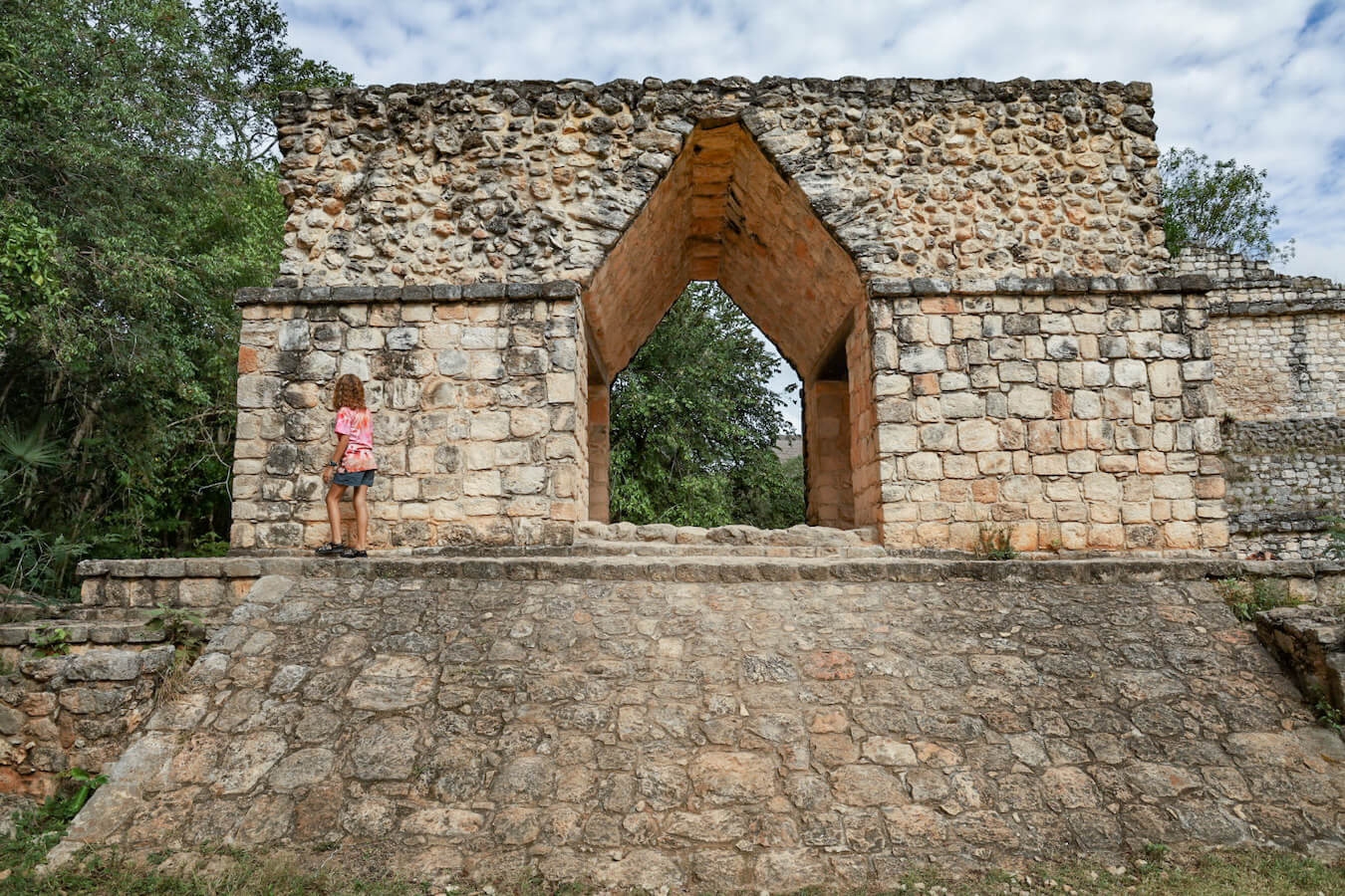 A child climbs the entrance arch at Ek' Balam ruins near Valladolid while on a self-guided tour.