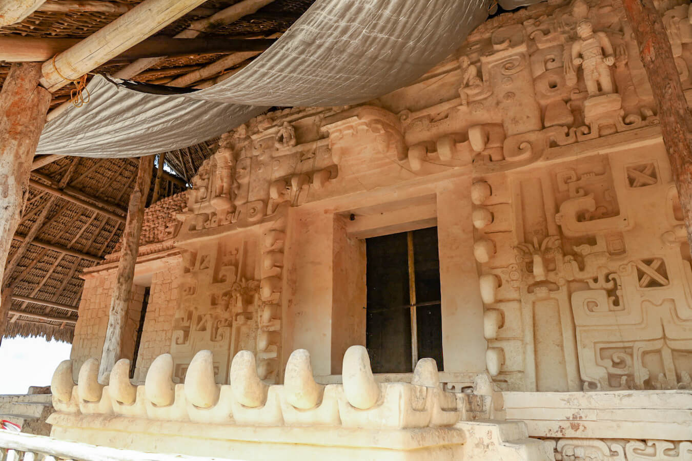 This is the Sak Xok Naah or White House of Reading.  White stucco carvings of giant fangs on the Acropolis at Ek' Balam ruins