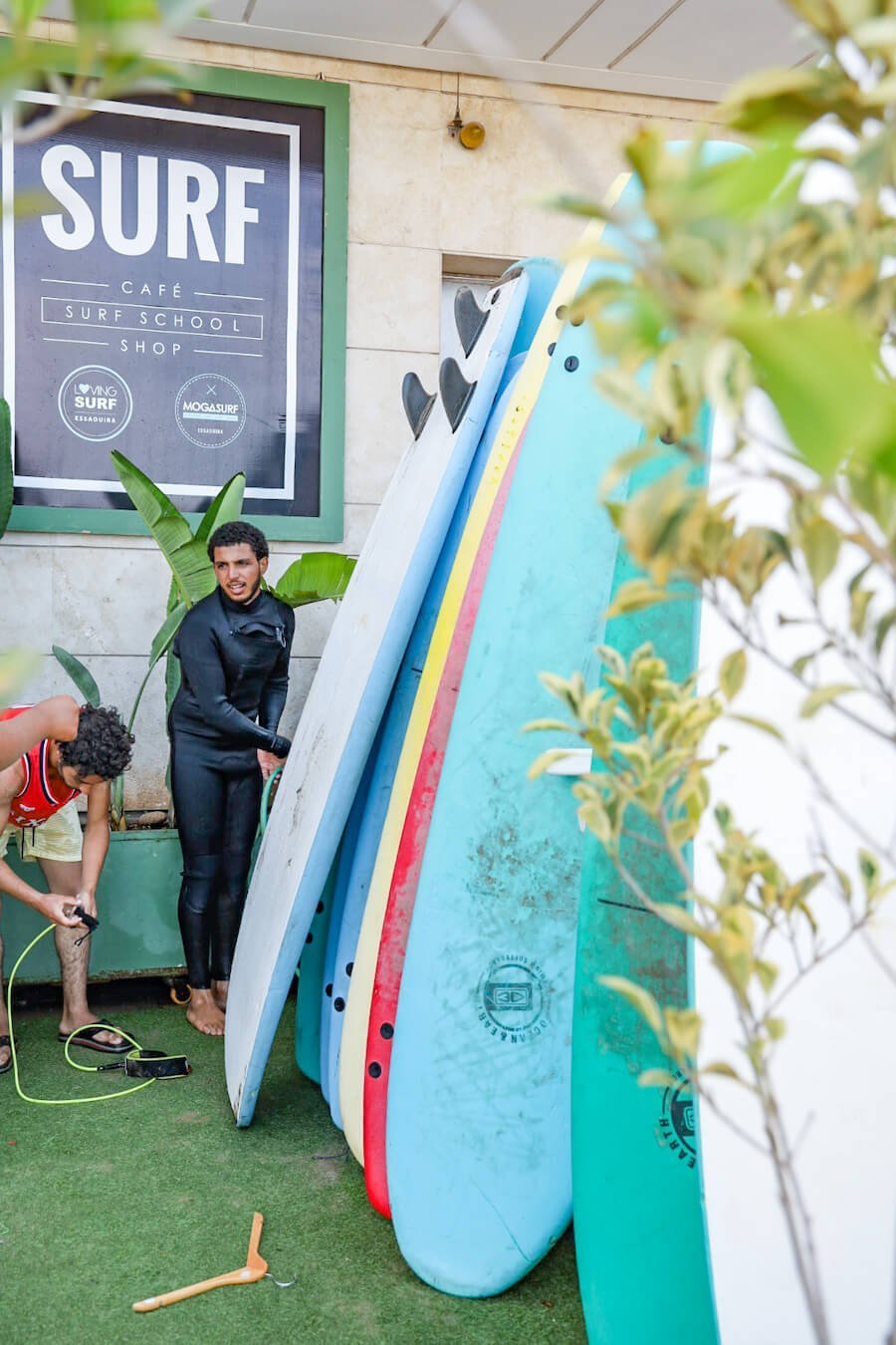 The team from Mogasurf wash down surf boards after a lesson.