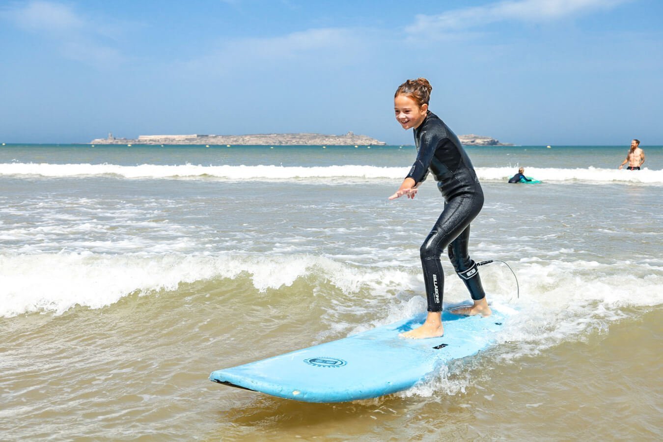 A child learns to surf in Essaouira, Morocco.  