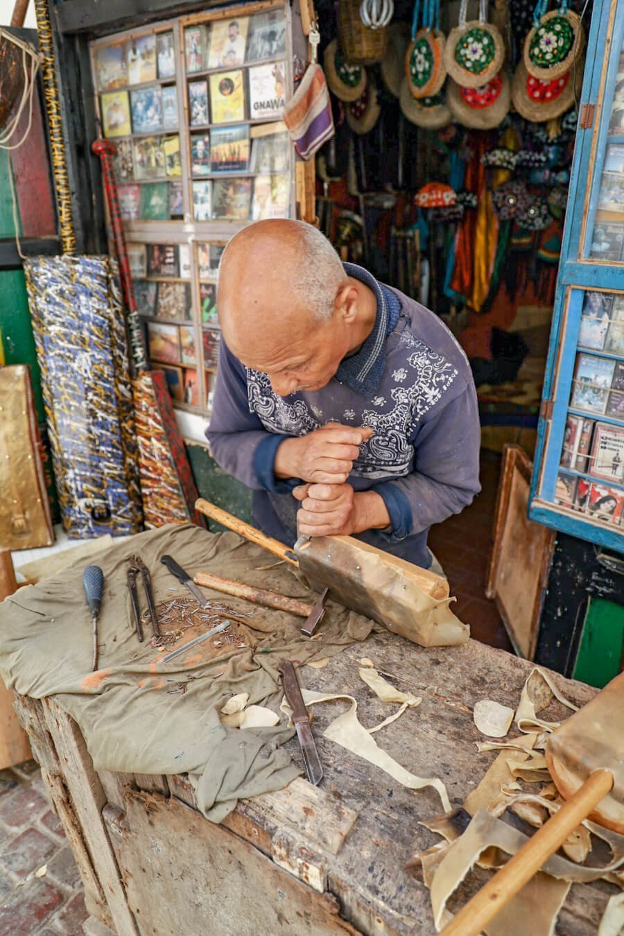 A man makes Gimbri and Sintir for Gnaoua music in Essaouira Medina
