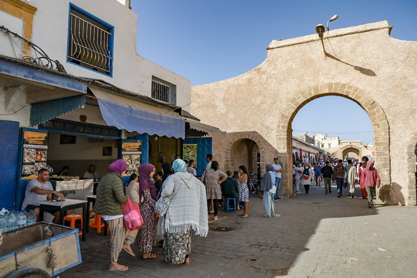 Local Moroccans wait for street food in Av. L'Istiqlal in the Essaouira Medina 