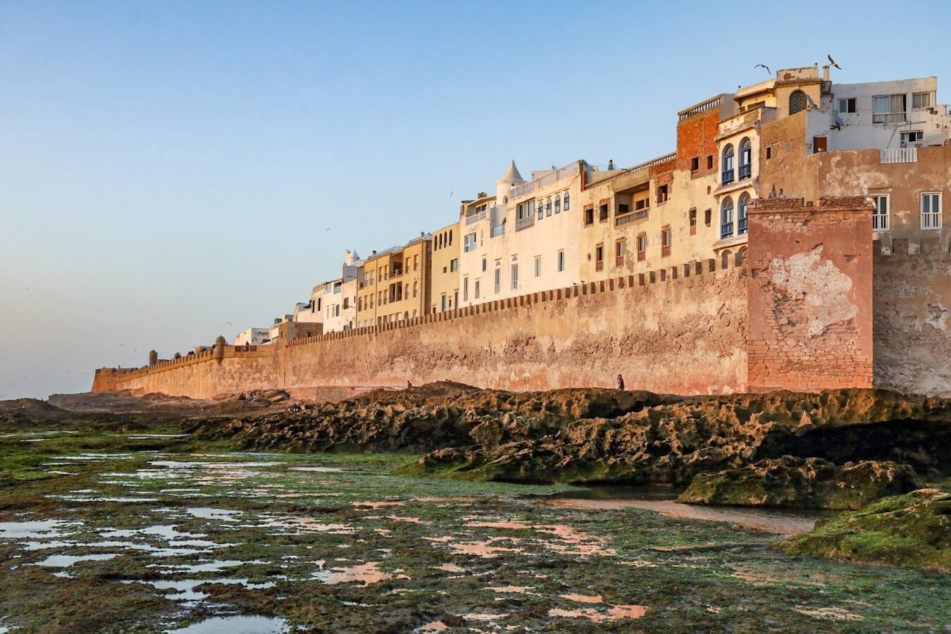 The rampart walls of the Essaouira Medina at sunset - a travel guide