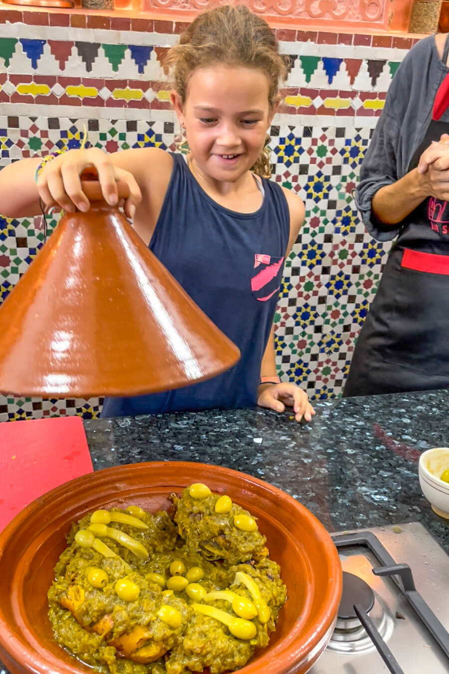 Unveiling the chicken tagine made in a family cooking class in Fes, Morocco