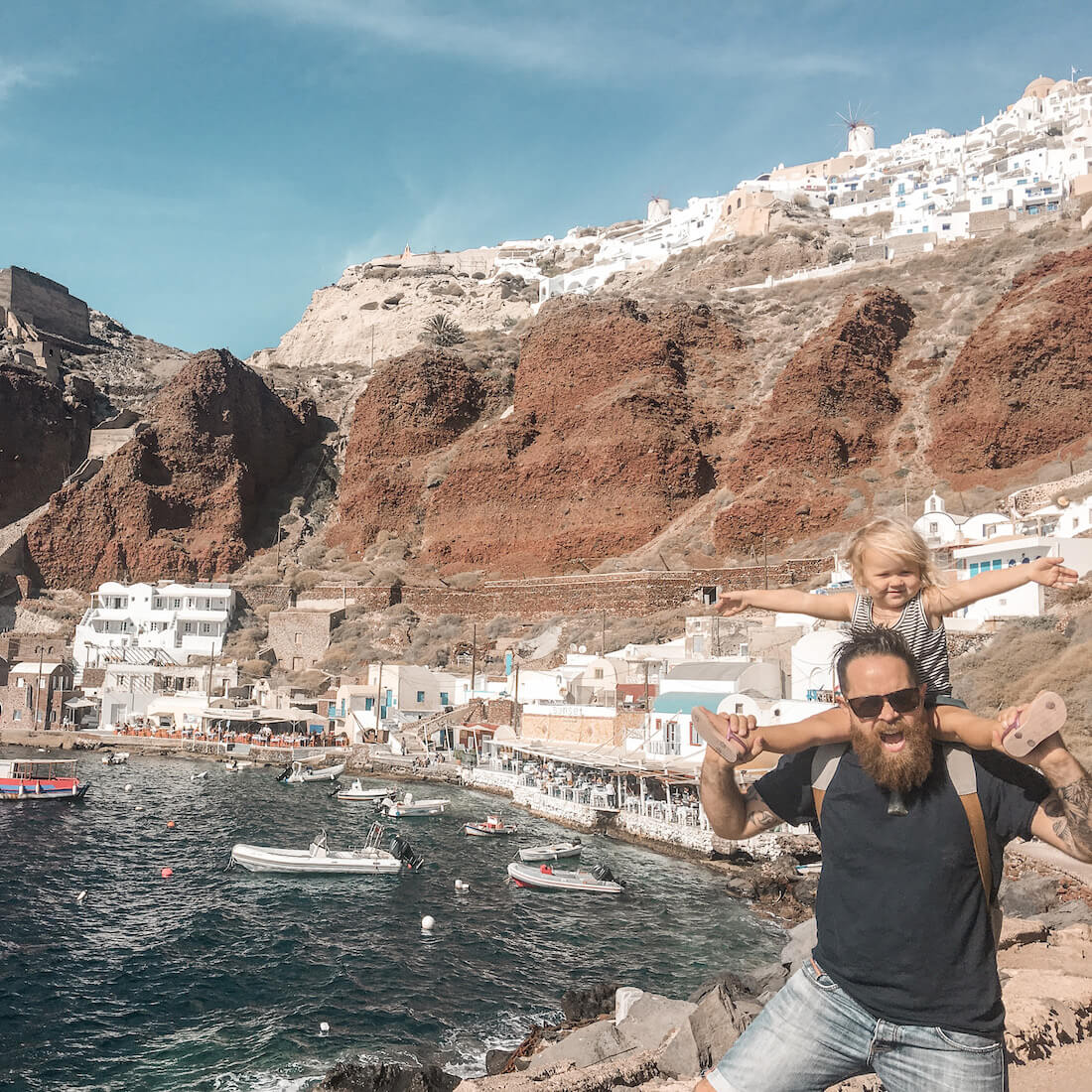 Father and child in Santorini in Greece - exploring Greece with kids is so easy if you know how to do it.