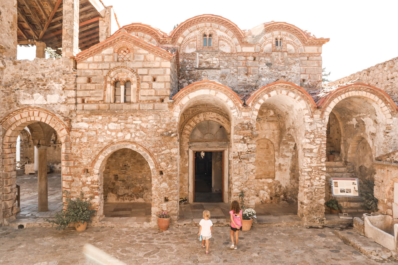 Kids enter ancient church in Sparta Greece