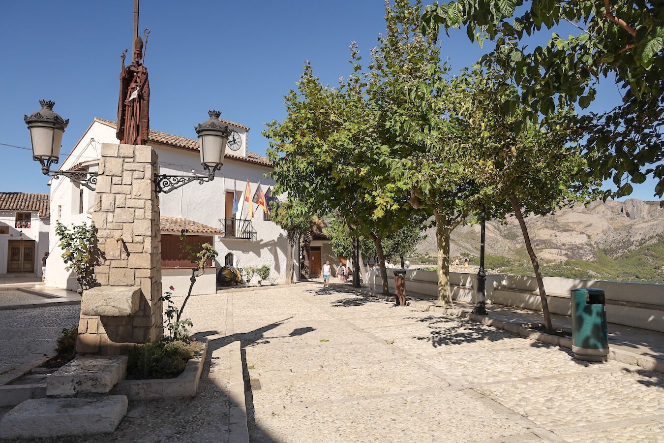 The Plaza San Gregorio and statue in the walled city of Guadalest Castle - a popular day trip destination from Javea.