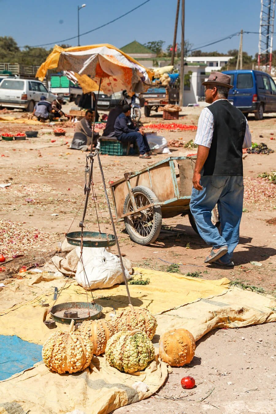 A man walks past a pumpkin stall at Ida Ougourd Market near Essaouira in Morocco