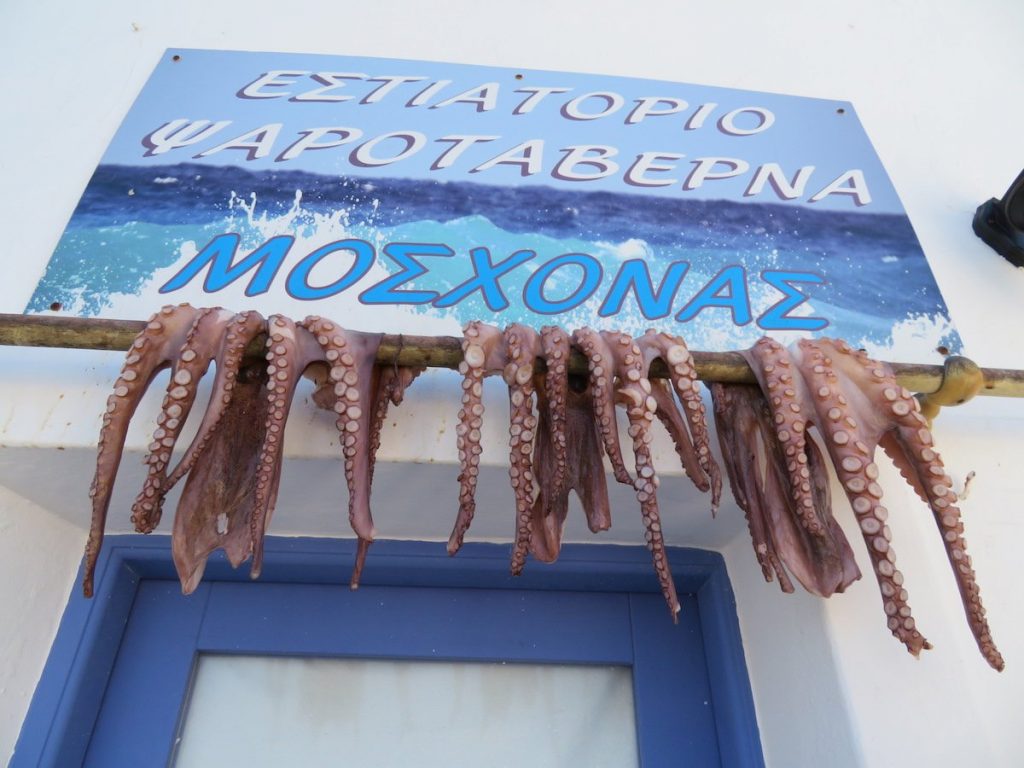 Octopus hangs from a restaurant early in the morning