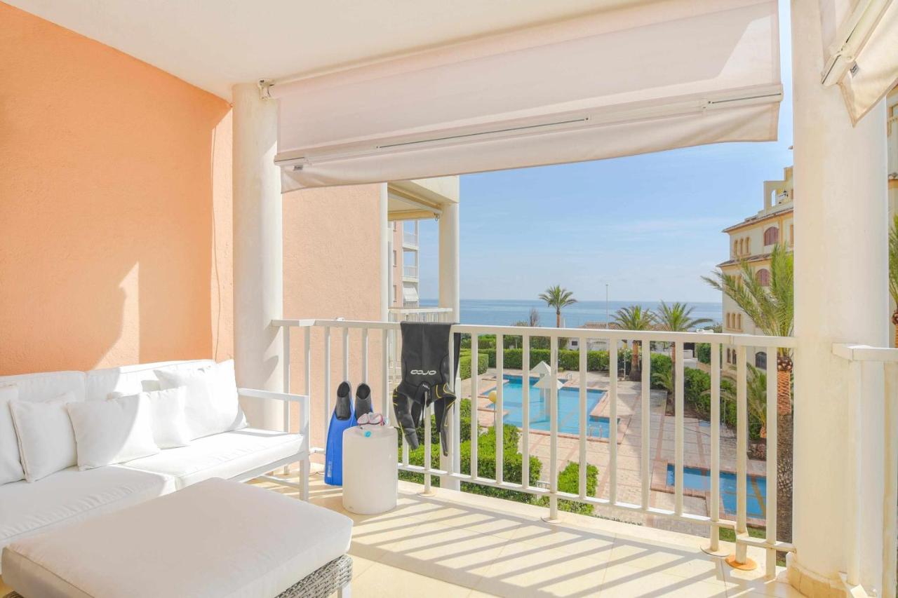An apartment terrace overlooking a pool, a holiday accommodation option for rent in Javea.
