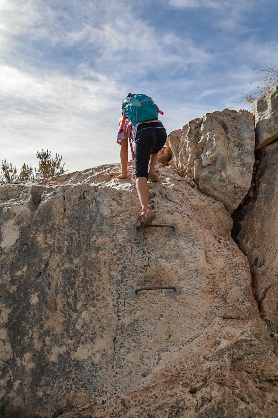 A child climbs the rungs on a more challenging part of the PR CV-354 Granadella walking trail in Javea.